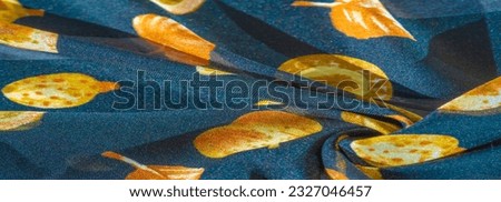 Texture, background, pattern, silk fabric, blue with a print of yellow autumn leaves.