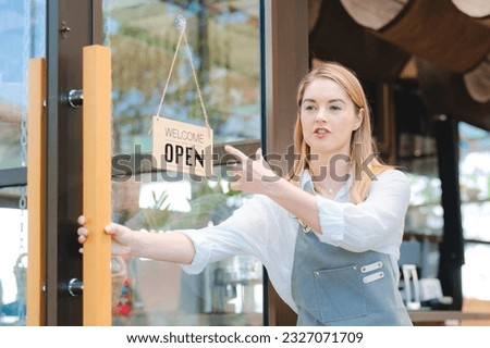 business cafes owner woman or barista worker wearing apron opening a coffee shop to start a business in the morning, female person waitress occupation job service for cafeteria restaurant, door open