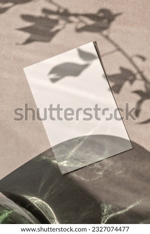 Sustainable business brand template, wedding invitation design. Blank paper card mockup with copy space on a neutral beige background with aesthetic floral sunlight shadow.