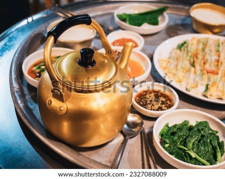 Makgeolli drink with Korean traditional food Pajeon on table Local Restaurant Korea travel  Royalty-Free Stock Photo #2327088009
