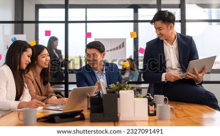 Group of asian business meeting and discussing strategy startup project analysis finance process.Success asian business people work plan and brainstorm marketing idea with laptop in office.Teamwork