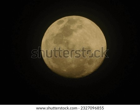 photo of a yellow full moon on a black background