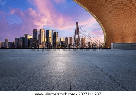 Empty floor and city skyline with modern buildings at sunrise in Chongqing, China.