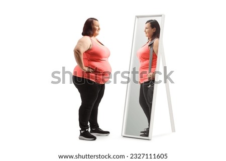 Overweight woman looking at a slimmer version of herself in the mirror isolated on white background Royalty-Free Stock Photo #2327111605