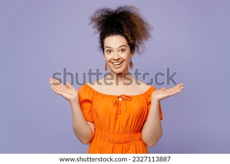 Young surprised excted amazed overjoyed latin woman she wear orange blouse casual clothes look camera spread hands isolated on plain pastel light purple background studio portrait. Lifestyle concept Royalty-Free Stock Photo #2327113887