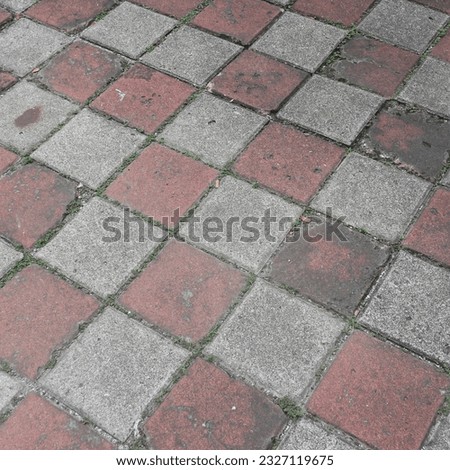 Coble stone background. Close up top view brick stone. Sidewalk or pavement.