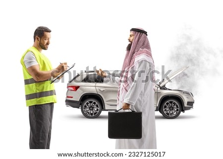 Saudi arab man with a car problem talking to a roadside assistant isolated on white background