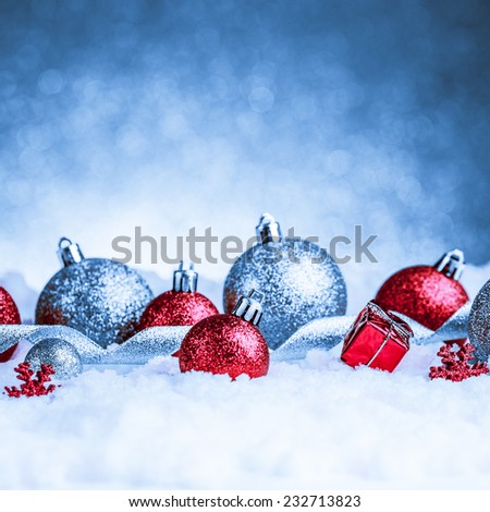 christmas ornament in snow on glitter background. studio shot
