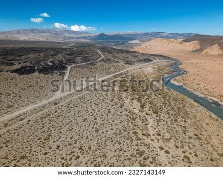 Aerial view of the remote and scenic nature with branches of the river Rio Grande along the famous Ruta40 in Mendoza Province in Argentina - Traveling South America 