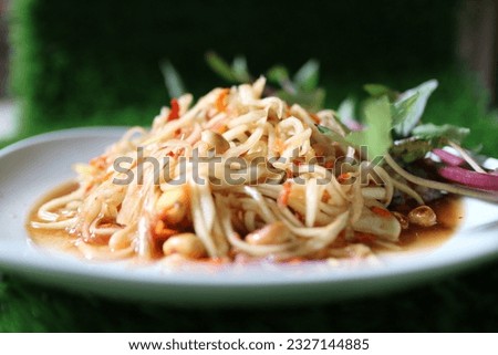 Papaya salad is a food prepared from making papaya salad.  is to sour  It is cooked by pounding, chopped or grated green papaya in a mortar.  Other ingredients include small tomatoes, black eggplants,