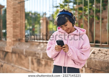 Young woman listening to music at street