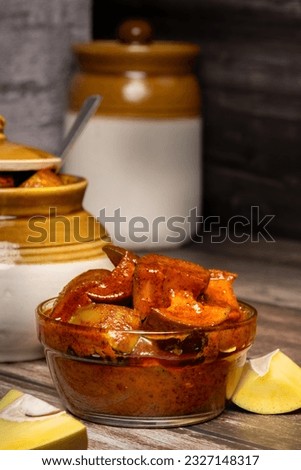 Traditional Andhra home made Totapuri raw mango sweet and spicy  pickle in a  south india traditional pickle storage jar - Selective focus Royalty-Free Stock Photo #2327148317