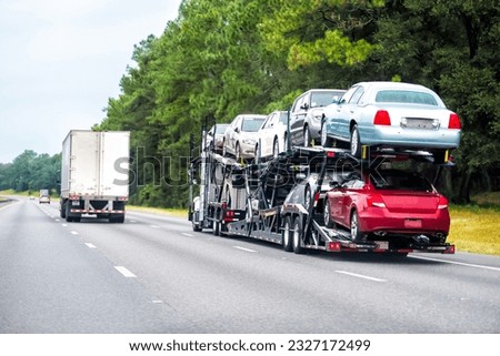 Truck trailer hauler transportation, commercial transport hauling brand new cars for auto dealership on Florida highway road Royalty-Free Stock Photo #2327172499