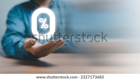 Businessman holding glowing zero percentage or 0 percent for special offer of shopping department store and discount concept.