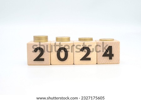 2024 written on wooden cubes with coins on white background. inflation concept, annual business, this year's economy