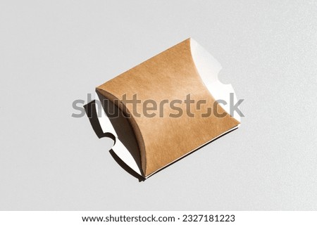 The box made of craft cardboard is collapsible. Gift box made of kraft paper. kraft paper wedding gift boxes creative pillow shape handmade jewelry packaging Royalty-Free Stock Photo #2327181223