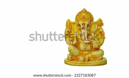 Statue of Hindu god Ganesha on white background. Colorful statue of Ganesha Idol on plain bright white background. Clear space for text or headline. Royalty-Free Stock Photo #2327183087