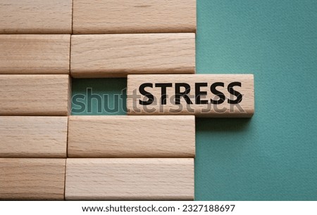 Stress symbol. Concept word Stress on wooden blocks. Beautiful grey green background. Medicine and Stress concept. Copy space.