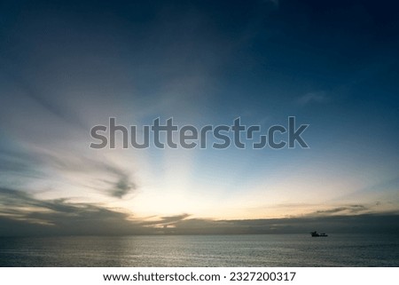 Sunset sky and boat in the middle of the sea nature