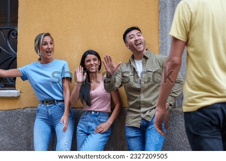 Three friends embrace the spirit of camaraderie, eagerly waiting as one of their own arrives, their expressions overflowing with pure joy against the backdrop of a city wall.