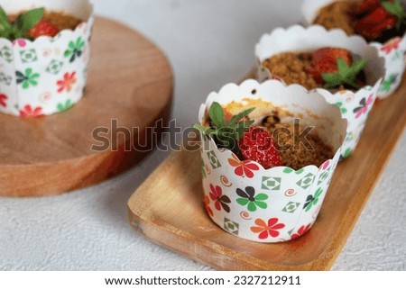 A cupcake is a small cake designed to serve one person, which can be baked in small cheesecloth or aluminum cups, has a strawberry flavor.