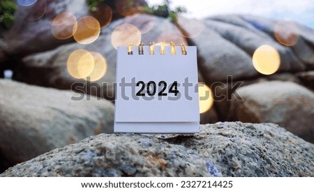 Paper mockup with 2024 and happy new year writing over beach sand background, banner with copy space for text, new year greeting card template Royalty-Free Stock Photo #2327214425