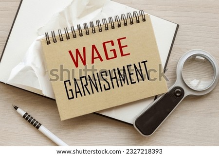 Wage Garnishment. craft notepad with a spring. text on the page Royalty-Free Stock Photo #2327218393