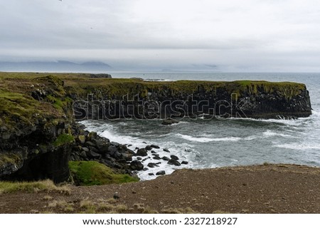 Waves washing against black basalt cliffs at Arnarstapi Cliffs in Snaefellsnes Peninsula, Iceland Royalty-Free Stock Photo #2327218927