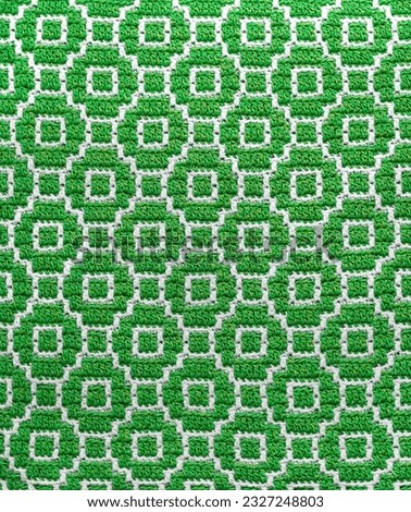 Seamless crochet texture with abstract mosaic pattern. Green white knitted background.