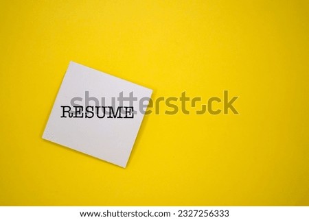 White sticky note with the word RESUME on yellow background