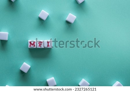 There is white cube with the word MFI. It is an abbreviation for Mobile First Index as eye-catching image. Royalty-Free Stock Photo #2327265121