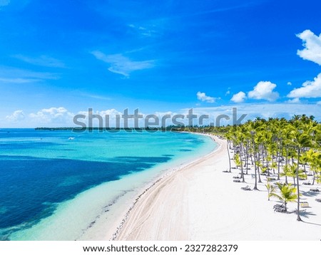 Aerial view of beautiful Bavaro beach with white sand and palm trees. Turquoise water and blue sky. Summer vacation in the all inclusive resort and hotel of Punta Cana Royalty-Free Stock Photo #2327282379