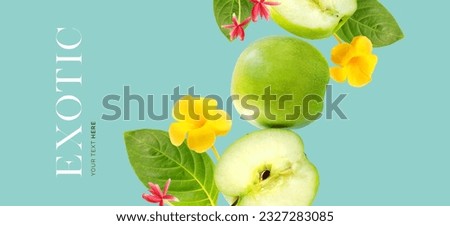 Creative layout made of green apple on the blue background with exotic flowers and leaves. Flat lay. Food concept. Macro  concept. Royalty-Free Stock Photo #2327283085