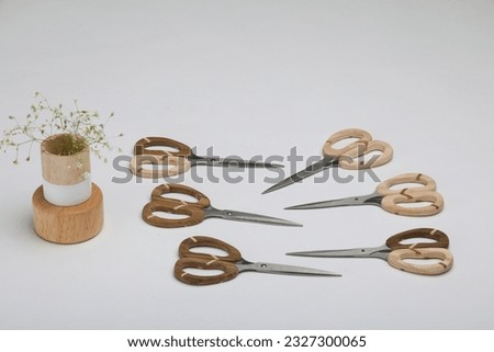 Artisanal Wood and Metal Scissors: Embrace the artistry of craftsmanship with these artisanal wood and metal scissors. The handles are meticulously carved from premium hardwood, showcasing the natural