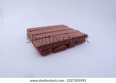 Stack of crunchy delicious wafers, chocolate cream flavor on white background