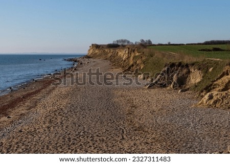 Cliff coast with path by the Baltic Sea. Royalty-Free Stock Photo #2327311483