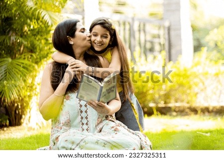 Cute little girl hug cuddle excited young mum show love and affection, smiling mother and funny small preschooler daughter have fun at home embrace sharing close tender moment together