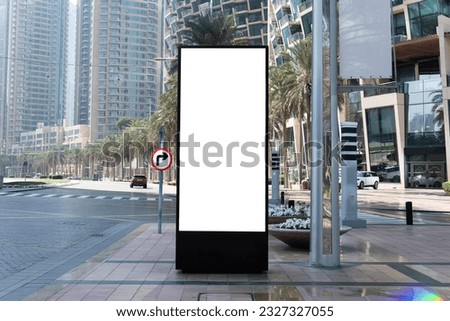 Blank mock up of vertical street poster billboard on city background. Electronic modern empty scoreboard on the background of a city street. copy space