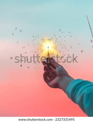 Bulb in hand with design into sky