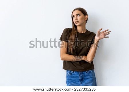 Whats your problem. Arrogant snobbish young brunette in red t-shirt shrugging raise hands look with disdain and confusion, feeling questioned and bothered with strange accusation, white background Royalty-Free Stock Photo #2327335235