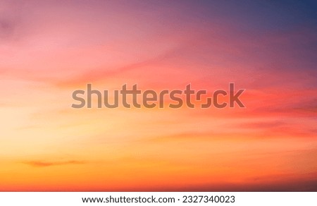 Sunset Sky Clouds in the evening with Red, Orange, Yellow and purple sunlight on Golden hour after sundown, Romantic sky in summer on Dusk Twilight  Royalty-Free Stock Photo #2327340023