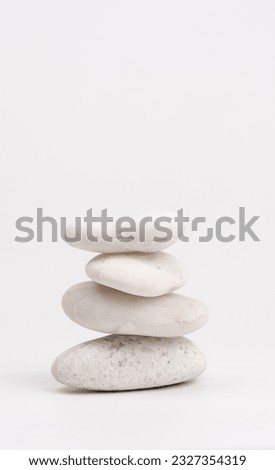 pile of white stones isolated on white background. Stones pyramid. Life balance and harmony concept.vertical.