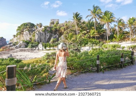 blonde woman in tulum ruin in mexico Royalty-Free Stock Photo #2327360721