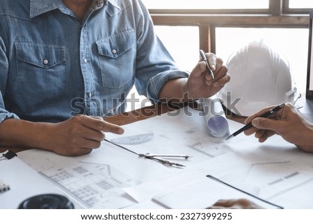 Architects interior designer hands working with Blue prints and documents for a home renovation for house design. Royalty-Free Stock Photo #2327399295