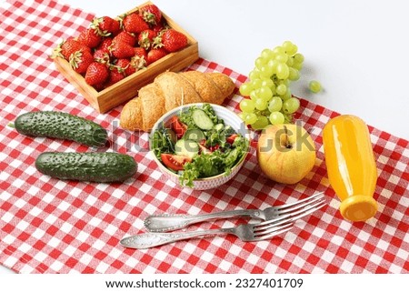 Bowl with salad, tasty food and juice for picnic on white background