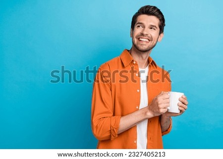 Portrait of positive minded creative person hands hold coffee mug look empty space brainstorming isolated on blue color background Royalty-Free Stock Photo #2327405213