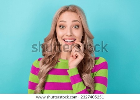 Portrait of optimistic satisfied impressed girl wear stylish clothes finger on lips astonished staring isolated on blue color background