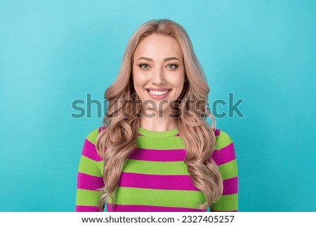 Photo portrait of pretty young girl toothy smile look camera wear trendy striped outfit isolated on cyan color background