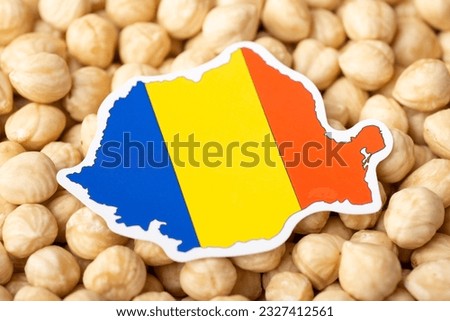 Flag and map of Romania on hazelnuts. Developing agriculture of growing hazelnuts in Romania