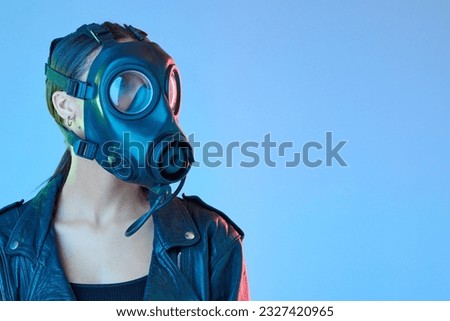 Mockup, protection and woman with a gas mask, breathing equipment and air pollution against a blue studio background. Female person, model and face cover with climate change, filter and radioactive